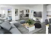 A modern living room with a sectional sofa, coffee table, TV, and dining area. Produktbild-Vorschau