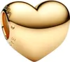 A close-up studio shot of a gold heart-shaped charm. Podgląd zdjęcia produktu