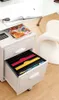 A close-up of a filing cabinet drawer organizer with colored folders. Anteprima dell’immagine prodotto