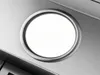 A close-up view of a circular light fixture on a brushed metal surface. Voir les images du produit