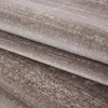 A close-up view of a folded carpet with a textured, mottled pattern. Podgląd zdjęcia produktu