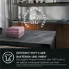 A stack of folded towels on a dark countertop in a laundry room setting, with a circular graphic overlay promoting hygiene. Produktbild-Vorschau
