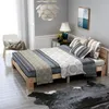 A bedroom scene with a bed, chair, and rug. Náhled obrázku produktu