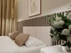 A bedroom scene with a bed, pillows, curtains, and a painting on the wall. Produktbild-Vorschau