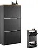 A black shoe cabinet with a wooden top, shown in two sizes against a white background. The larger cabinet has three flip-down doors, while the smaller one shows shoes inside its open compartments. Produktbild-Vorschau