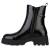 A black patent leather ankle boot with a thick lug sole is shown from the side against a white background. Produktbild-Vorschau