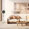 A stand fan is placed in a living room next to a sofa and coffee table. Produktbild-Vorschau