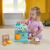 A young child is playing with a toy coffee maker. Náhľad obrázku produktu