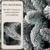 A close-up of a frosted artificial Christmas tree branch, with a text box on the left detailing its material and durability. Produktbild-Vorschau