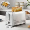A stainless steel toaster with two slices of toast is shown on a kitchen counter, with dimensions indicated by lines and text. Produktbild-Vorschau