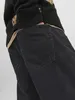 Close-up of the back pockets of black jeans and a black sweater. Produktbild-Vorschau