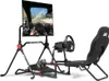 A racing simulator cockpit with a monitor, steering wheel, pedals, and seat, set against a white background. Produktbild-Vorschau