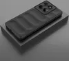 A black phone case with a textured back and a camera bump is displayed on a gray platform. Náhled obrázku produktu