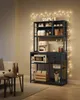 A dark gray metal kitchen baker's rack filled with coffee-related items and appliances, illuminated by string lights. Náhled obrázku produktu