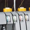 Close-up of the dials and thread spools on a sewing machine. Produktbild-Vorschau