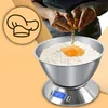 A person is cracking an egg into a bowl of flour on a digital kitchen scale. Produktbild-Vorschau