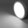A white, circular LED ceiling light is shown against a gray background, casting a bright light and shadow. Produktbild-Vorschau