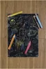 A scratch art drawing of a space scene with rockets, planets, and stars, along with several colored pencils and crayons. Voir les images du produit
