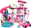 A Barbie Dreamhouse playset with multiple dolls and accessories, including a pool and a car. Anteprima dell’immagine prodotto