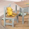 A child's chair and table set with a stuffed toy on the chair. Produktbild-Vorschau