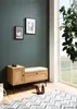 A hallway bench with storage, next to a window with plants. Voir les images du produit