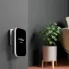 A wireless doorbell receiver is mounted on a gray wall next to a potted plant. Náhľad obrázku produktu