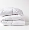 A stack of white duvets against a white background. Náhled obrázku produktu