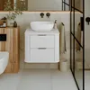 A modern bathroom vanity with a vessel sink, set against a tiled wall and next to a wooden cabinet and toilet. Produktbild-Vorschau