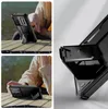 Collage of images showing a black phone case with a kickstand, being used outdoors and indoors. Náhľad obrázku produktu