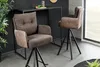Two bar stools are shown in a modern interior setting, with a bar table behind them. Produktbild-Vorschau