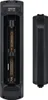 The image shows the back of a black remote control with the battery compartment open, revealing two AA batteries. The battery cover is placed next to the remote. Produktbild-Vorschau