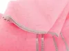 A close-up view of pink mesh fabric with gray trim. Produktbild-Vorschau