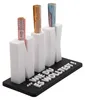 A white money holder shaped like the letters N, I, and X, with rolled banknotes inserted into each letter. The base has text printed on it. Produktbild-Vorschau