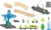 A collection of toy train set pieces, including tracks, a train, a gas station, figures, and accessories, laid out on a white background. Produktbild-Vorschau