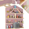 A wall shelf filled with various toys and a gray speaker-like device. Produktbild-Vorschau