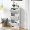 A white shoe cabinet with three flip-down drawers is shown in a room with a window and curtains. Anteprima dell’immagine prodotto