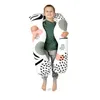 A young boy is holding a large, patterned pillow. Náhľad obrázku produktu