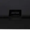 A close-up view of a black connector port on a black surface. Produktbild-Vorschau