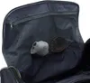 Close-up view of the interior of a dark-colored travel bag, showing a mesh pocket with a small gray item and a brown belt inside. Voir les images du produit