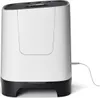 A white and black air purifier is shown against a white background with a power cord connected. Náhľad obrázku produktu
