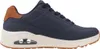 A side view of a single blue sneaker with brown accents and a white sole. Voir les images du produit