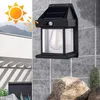 A solar-powered wall light is mounted on a tiled wall, with a graphic indicating solar charging and a depiction of mountains and a building in the background. Anteprima dell’immagine prodotto