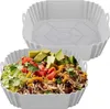 A reusable silicone liner for an air fryer, shown both empty and filled with food. Náhľad obrázku produktu
