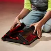 A person is kneeling and interacting with a Beyblade X Clash and Carry stadium. Anteprima dell’immagine prodotto