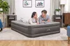 A couple lying on an inflatable mattress in a bedroom. Podgląd zdjęcia produktu
