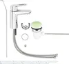 A set of bathroom faucet components, including the faucet itself, drain assembly, and connecting hoses, laid out on a white background. Voir les images du produit