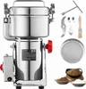 A stainless steel electric grain grinder with various accessories laid out around it. Voir les images du produit