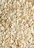 A close-up, overhead view of a pile of rolled oats. Produktbild-Vorschau