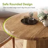 A close-up view of a round wooden dining table with a chair and flowers in the background. Produktbild-Vorschau