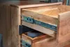 Close-up of an open wooden drawer with metal slides, revealing another drawer below. Produktbild-Vorschau